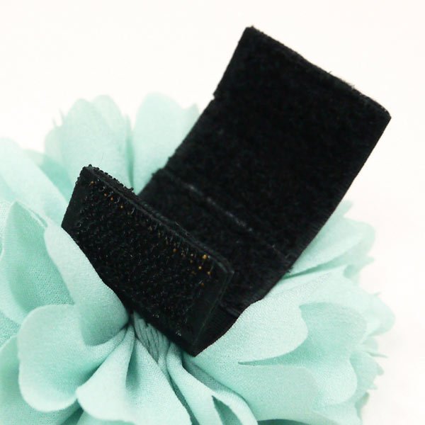 Light blue flower bow with black clip backing and rhinestone center