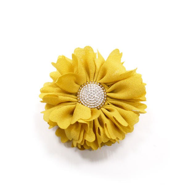 Yellow fabric flower rosette with white rhinestone button center.