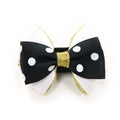 Black bow tie with white polka dots and gold ribbon tails