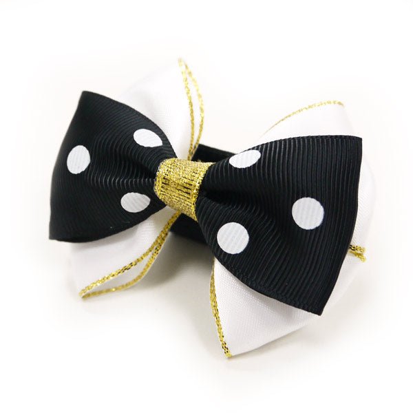 Black bow tie with white polka dots, gold knot and ribbon ends