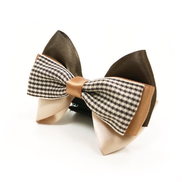 Beige bow tie with black-and-white houndstooth center and brown outer loops
