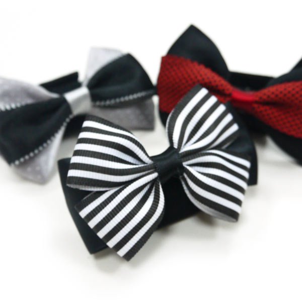Striped black bow tie with partially visible red and gray bows