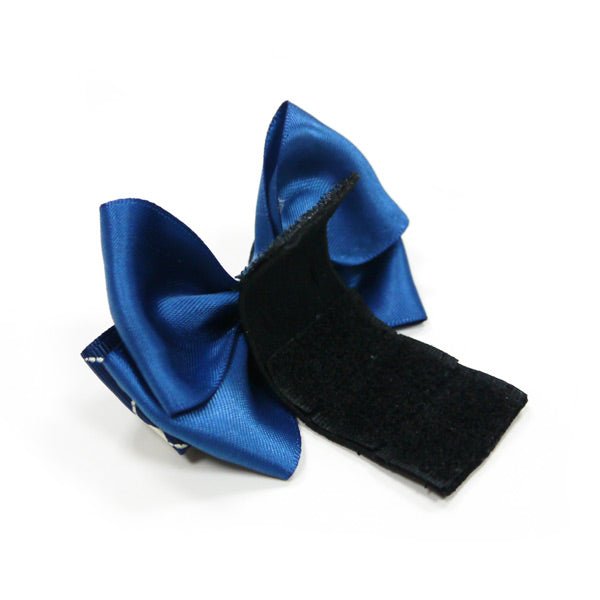 Blue bow tie with navy heart-and-ring pattern, side view with black clip