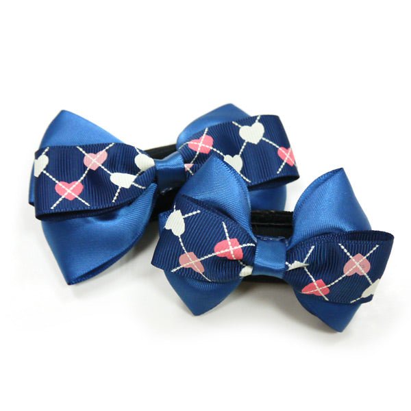 Blue bow tie with navy heart-and-ring pattern on black clip
