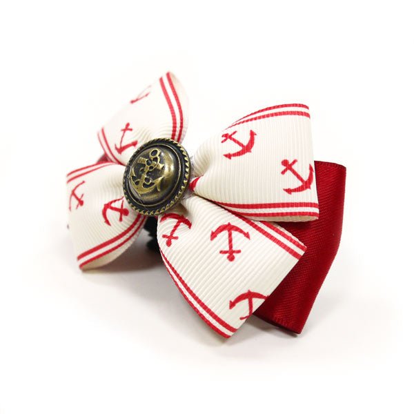 Nautical hair bow with red-and-white anchor pattern, stacked loops, and bronze center