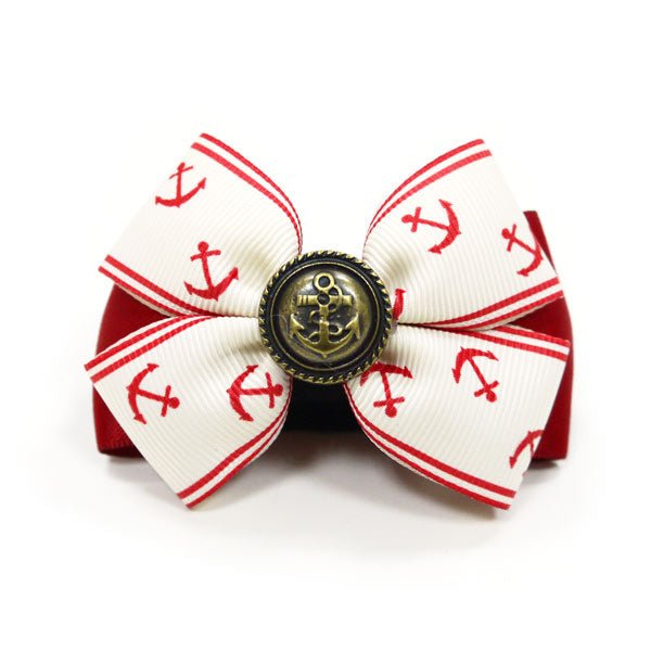 Nautical hair bow with red-and-white striped anchor print and bronze button center