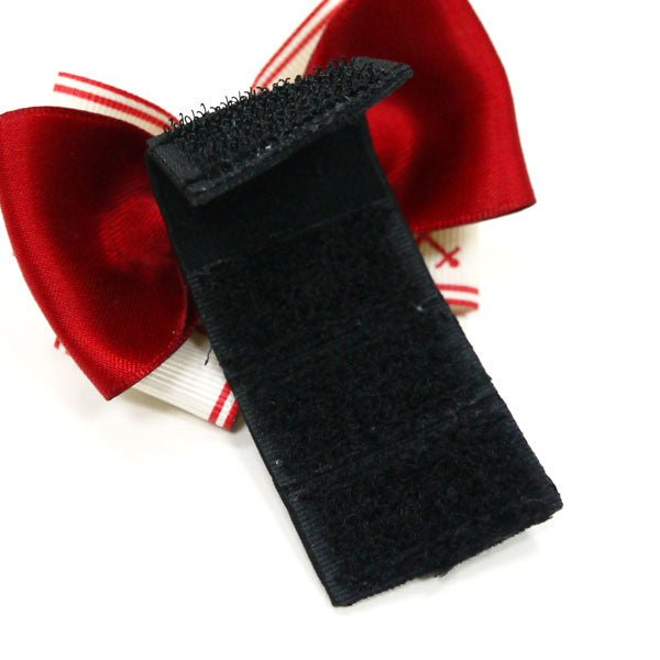 Nautical hair bow close-up with black fabric strip and red satin back