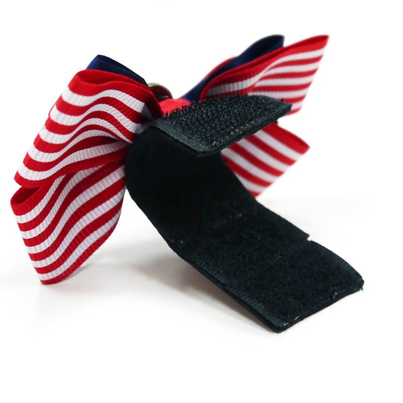 Nautical pet bow with red/white striped wings, dark blue ribbon tails, and red knot