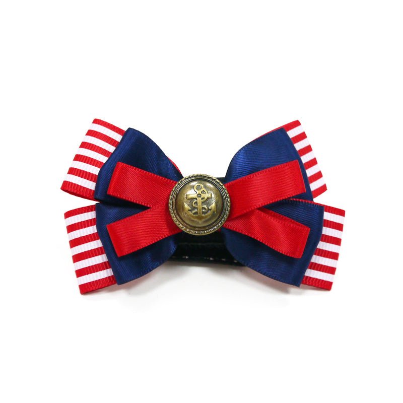 Nautical pet bow with red/white striped sides, dark blue bow loops, and gold button medallion