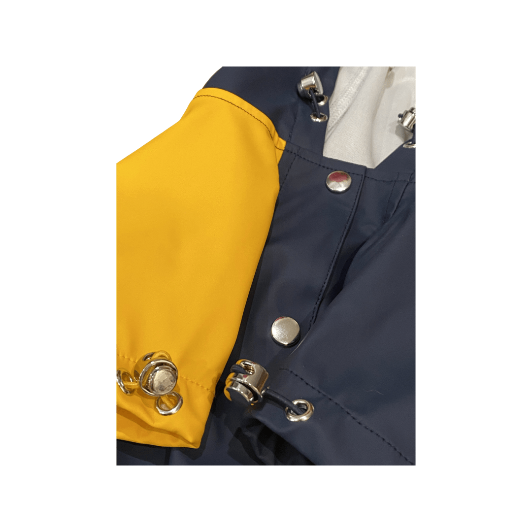 Pet raincoat side detail with yellow sleeve, metal snaps, and front zipper