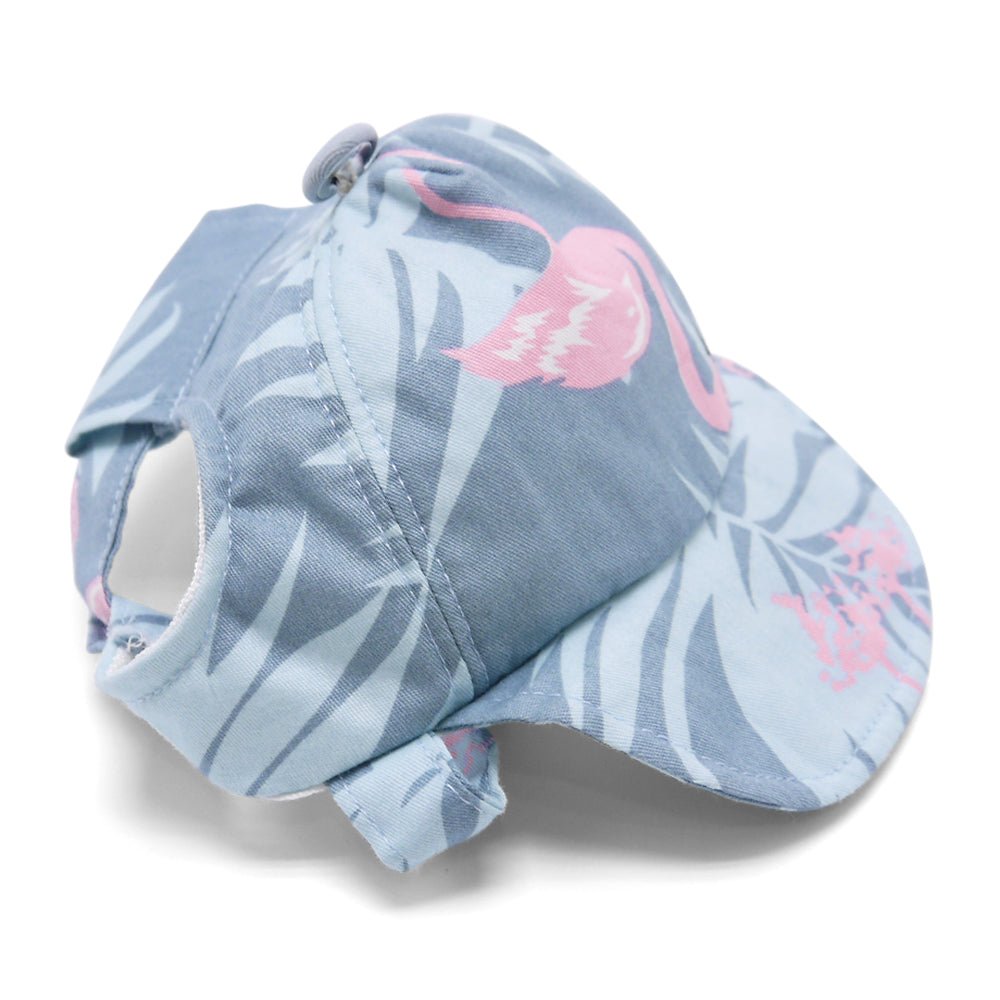 Light blue dog cap with flamingo print and brim, fabric loop on top.