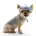 Light blue dog hat with flamingo pattern, wide brim, chin strap tied.