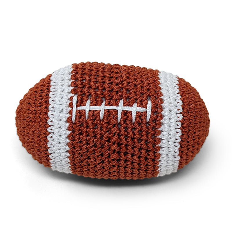 Crocheted football toy with brown body, white stripes, and stitched laces
