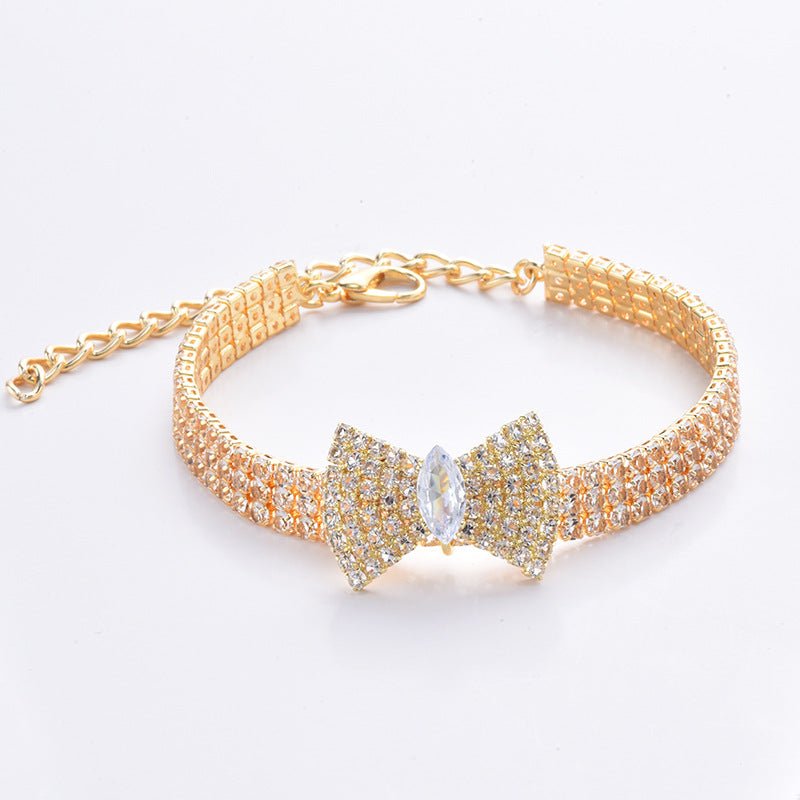 Gold crystal bow pet necklace with chain link clasp and rhinestone bow centerpiece