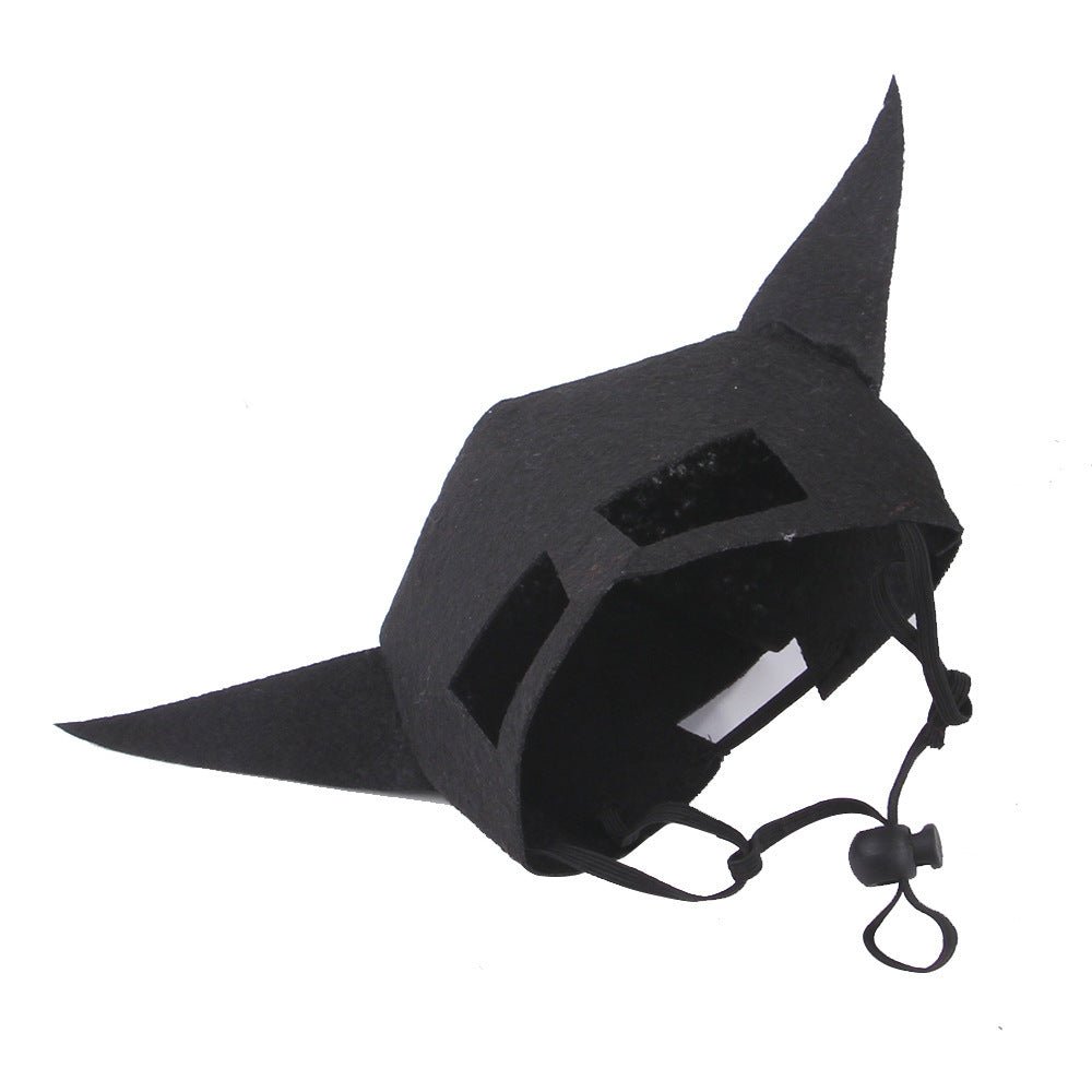 Black bat pet mask with pointed ears, face opening, and chin strap ties