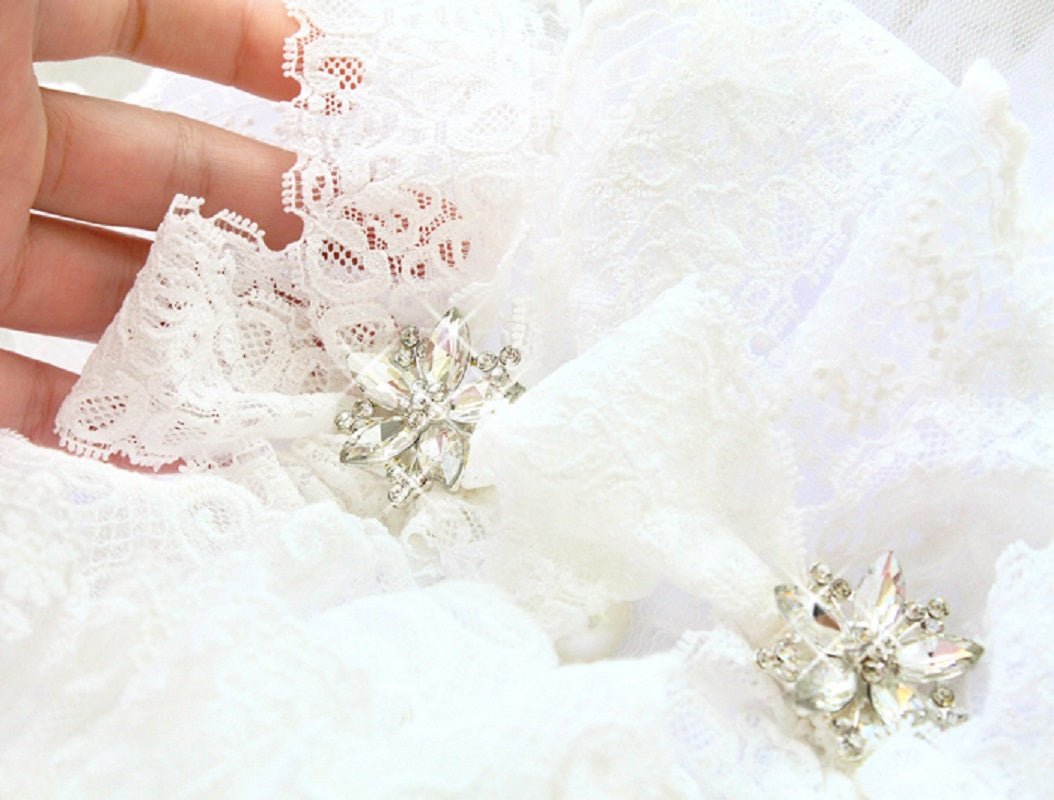 Ivory lace dog dress detail with gold star buttons on ruffled fabric