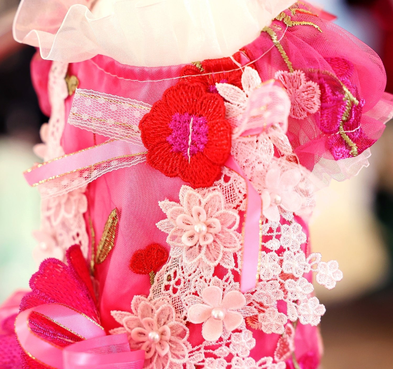 Hot-pink pet dress with lace yoke, large flower appliques, and ribbon bow sleeve