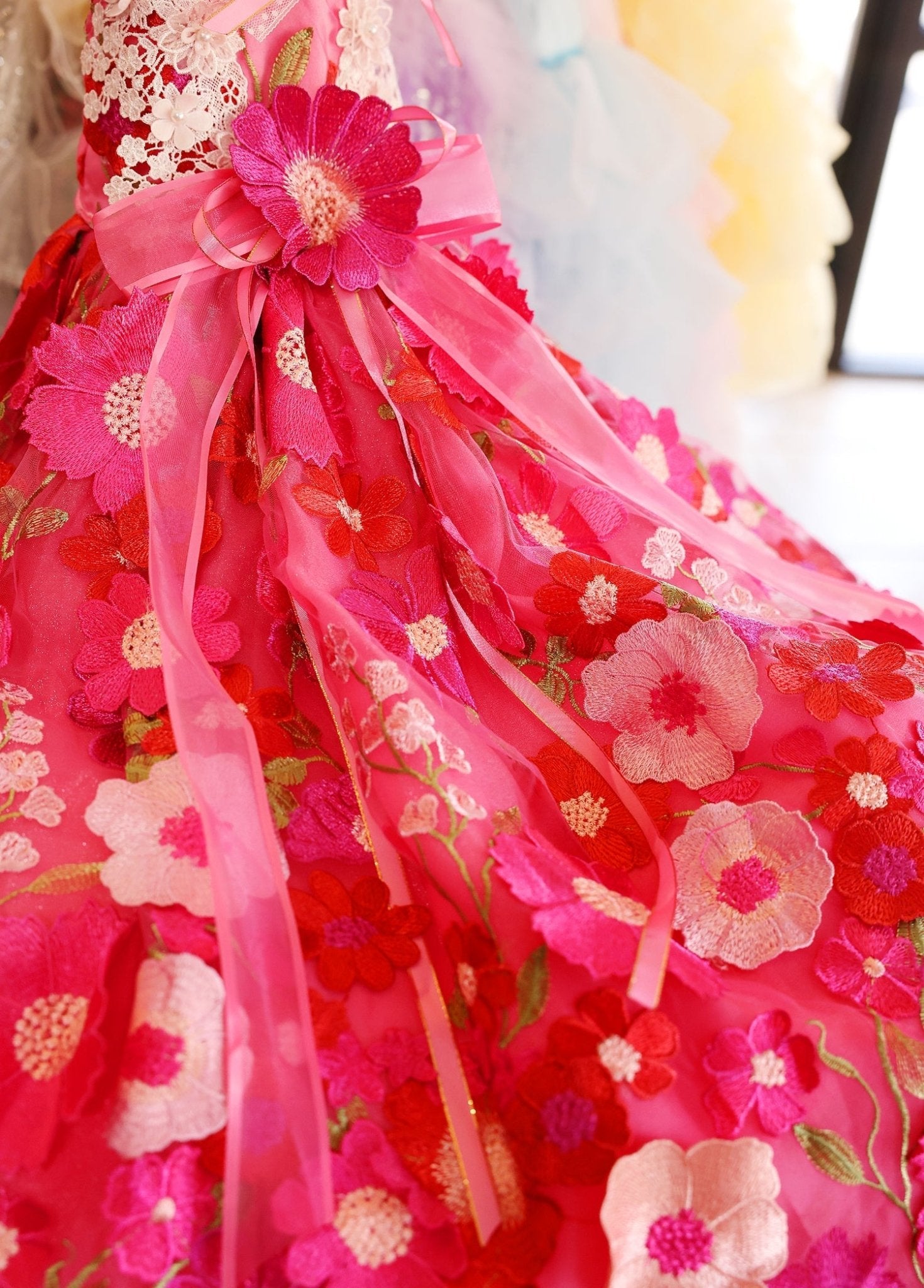 Hot-pink tulle pet dress with layered floral appliques and flowing ribbon details