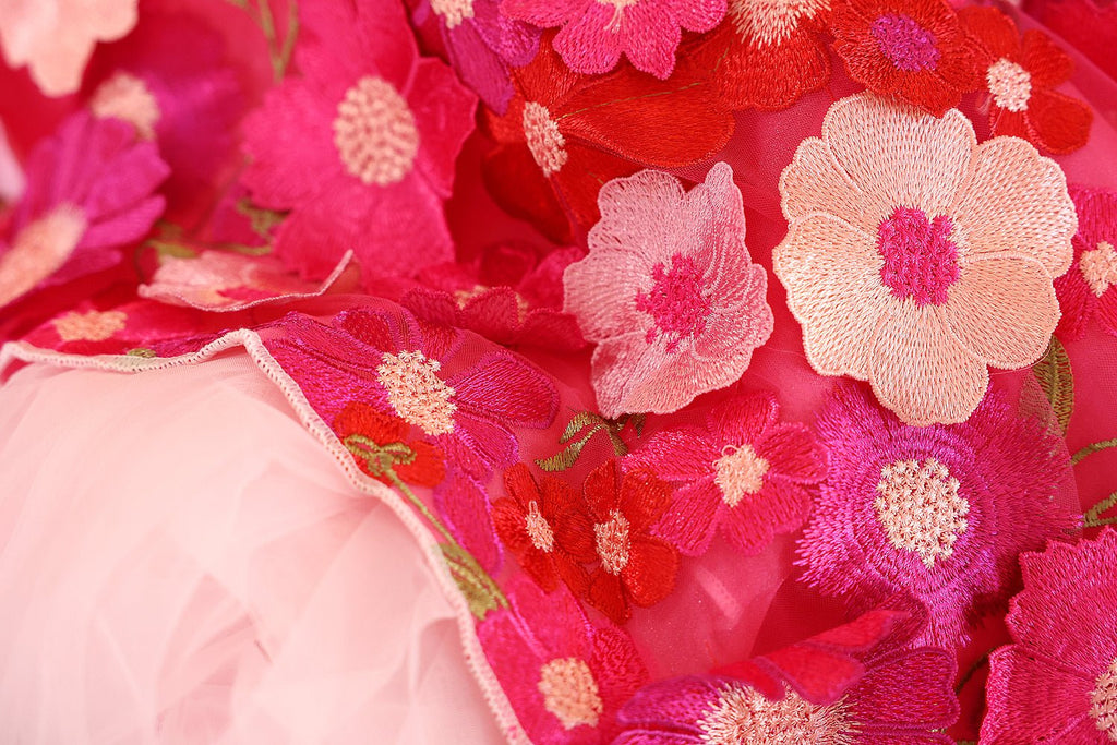 Hot-pink embroidered tulle fabric with floral blossoms and gold thread accents