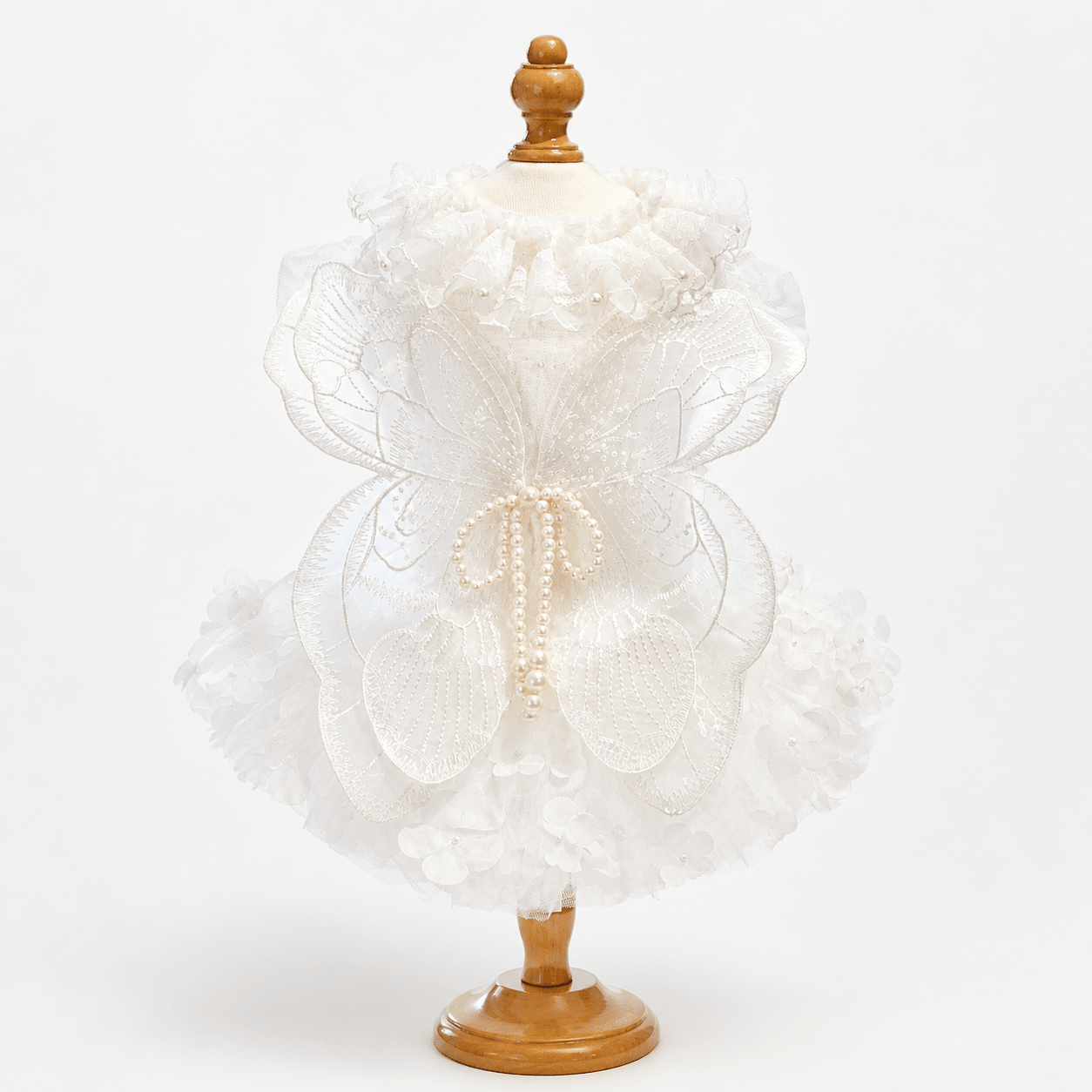 White pet wedding dress with large butterfly applique, pearl tassel center, and tulle skirt
