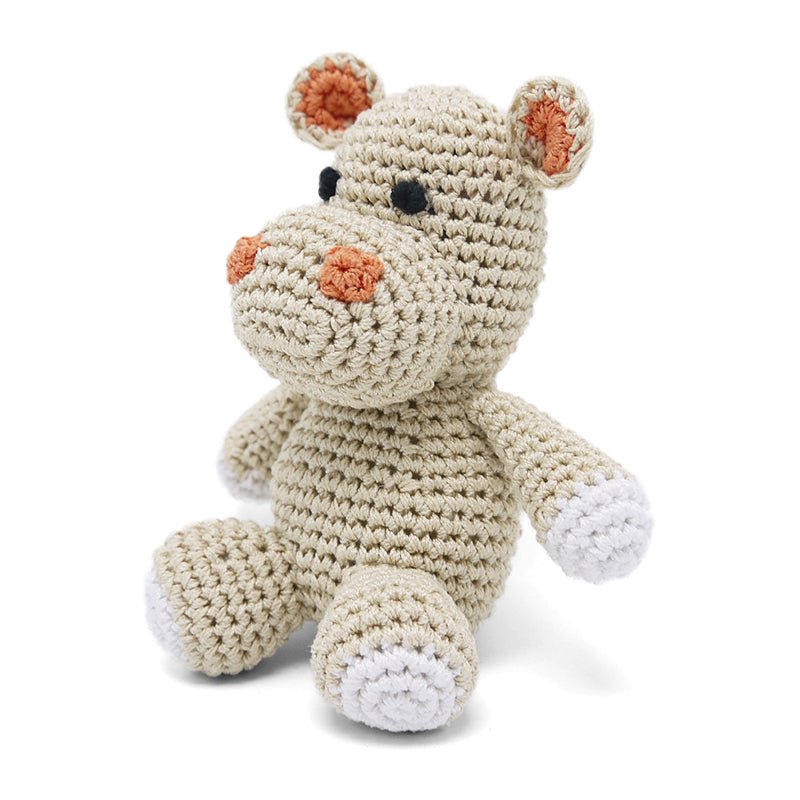 Crocheted hippo plush toy, cream body with orange nose patches and paw pads, button eyes.