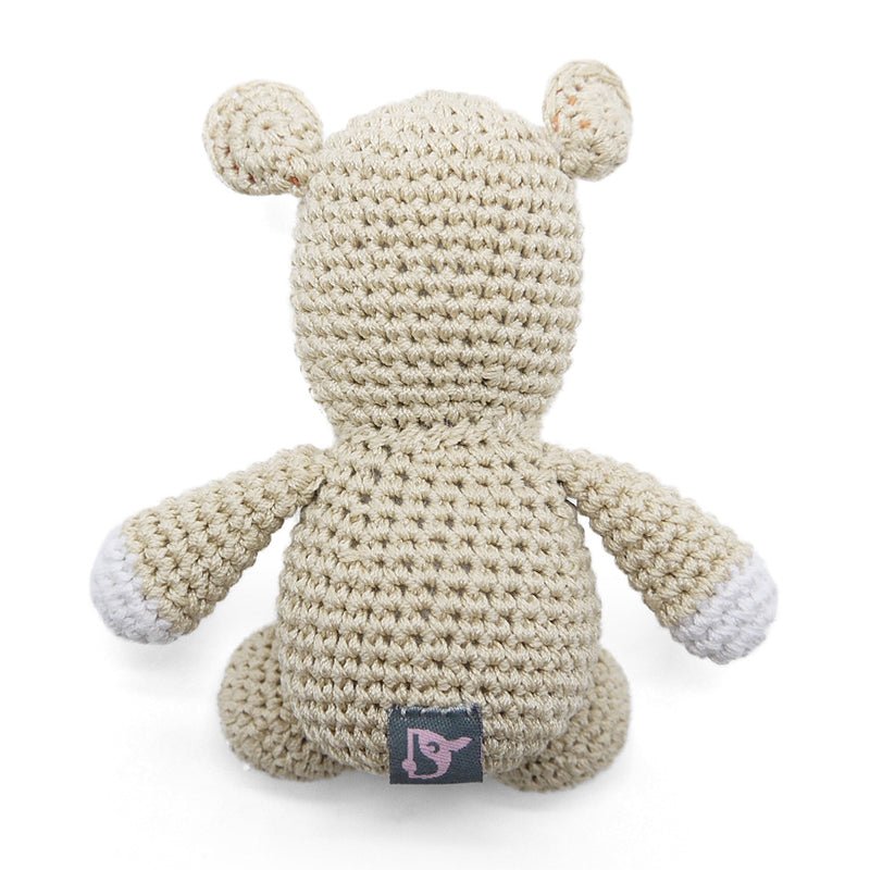 Crocheted hippo plush toy, cream textured body with small brand tag on belly.