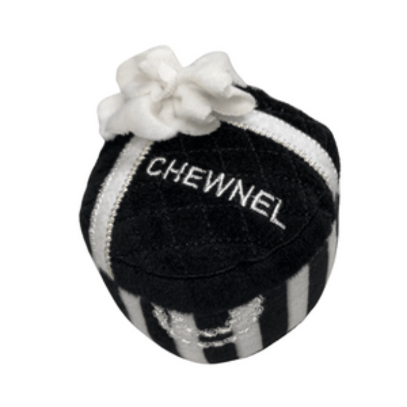 Black-and-white plush squeak ball with white flower and CHEWNEL logo