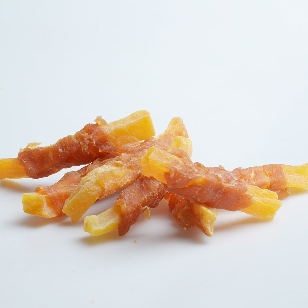 Chicken and sweet potato dog treat strips, mixed orange and yellow pieces