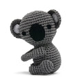 Crocheted koala toy in gray with black nose and round ears, sitting pose