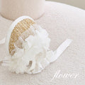 White straw hat with lace flower decoration and ribbon bow