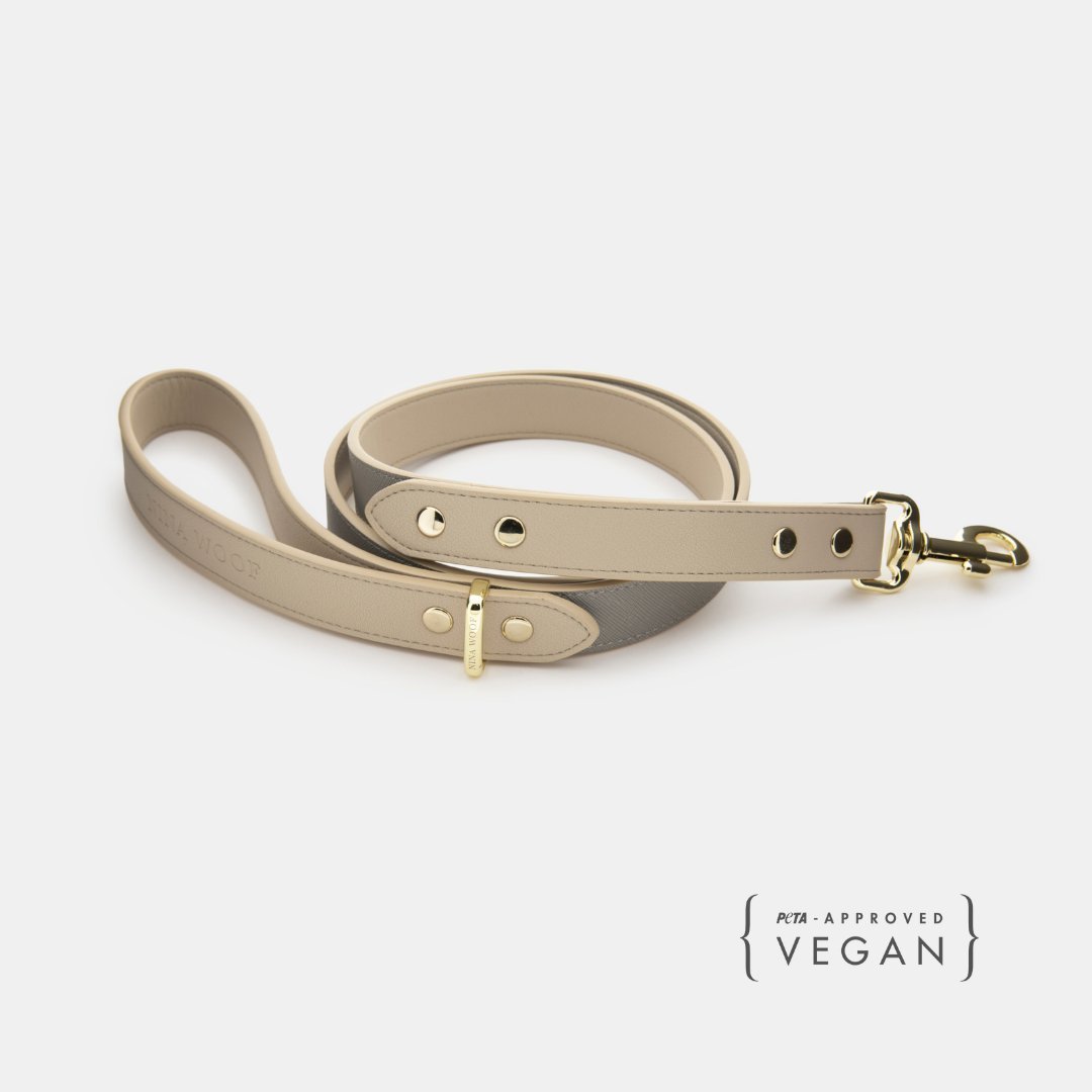 Beige vegan leather dog leash set with gold clip and buckle, laid flat
