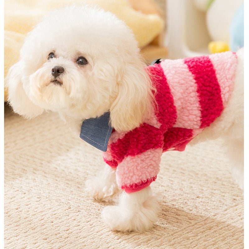 Small dog wearing red-and-white striped fleece pet sweater with denim collar and leash hole.