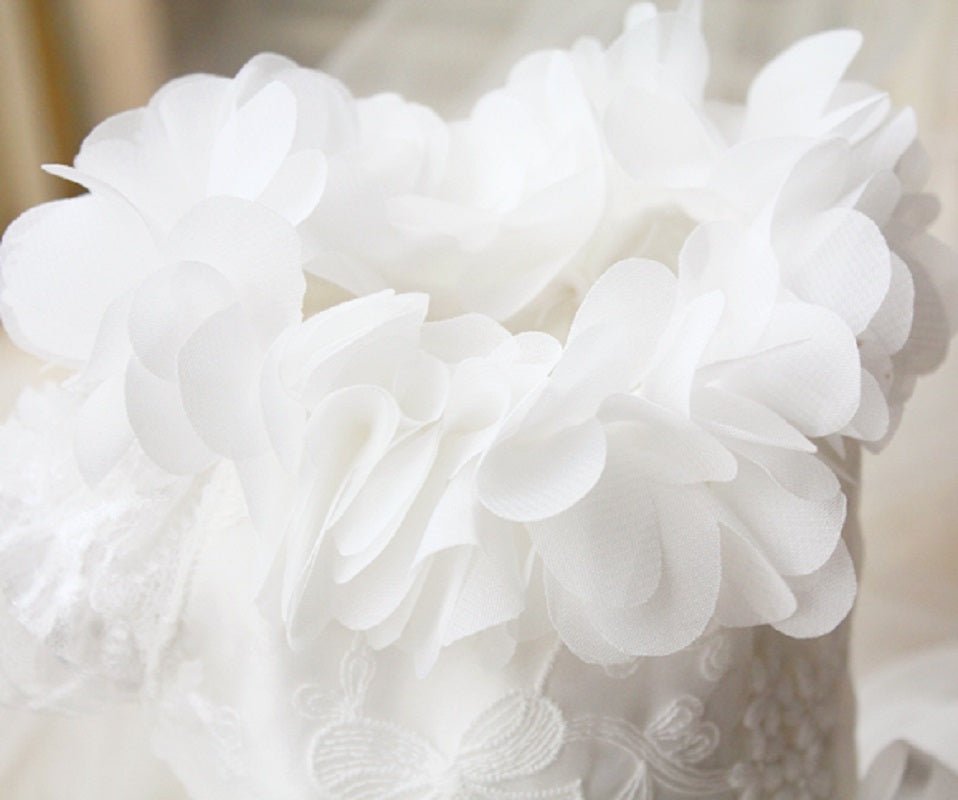 White pet wedding dress with oversized fabric flower detailing on bodice