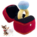 Red plush ring-box dog toy with blue ball and yellow ring