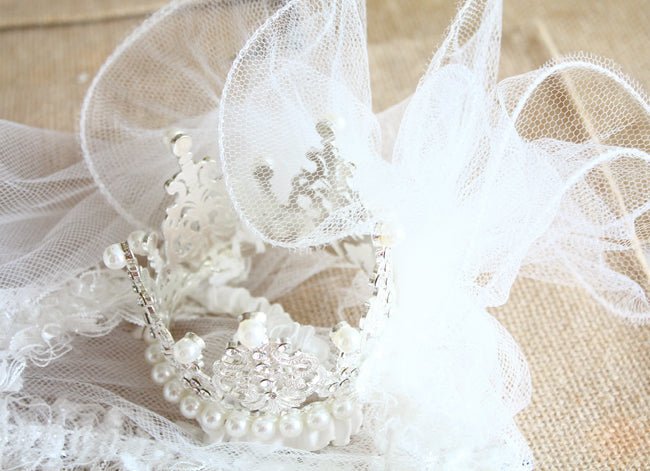 White pearl crown tiara with beaded details and tulle veil, close-up