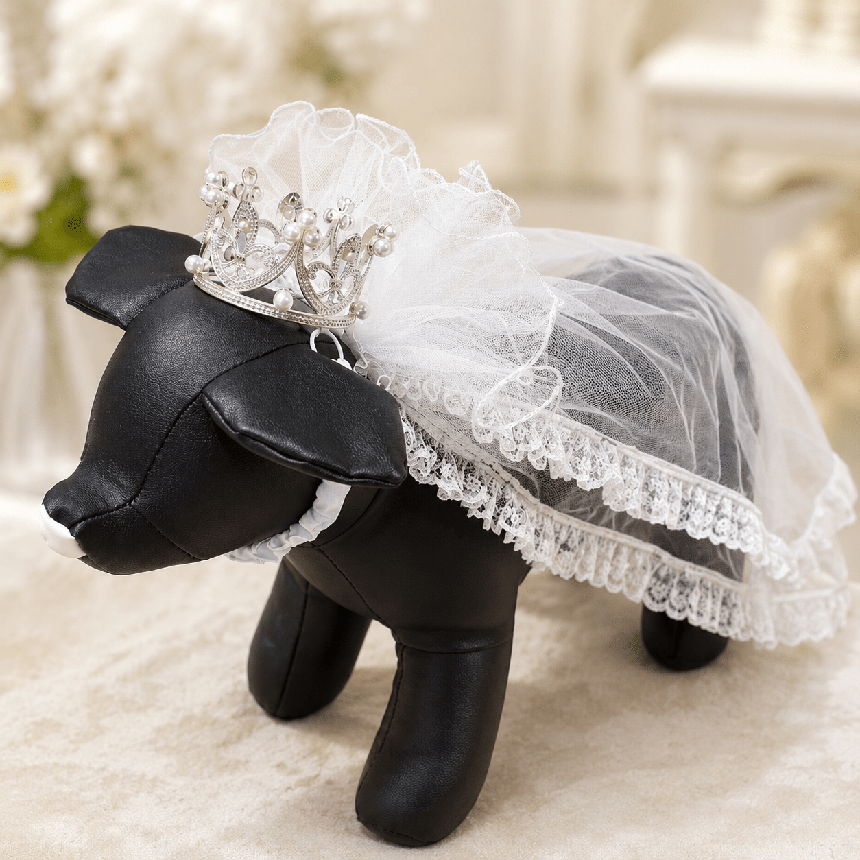 White bridal veil on a small black pet mannequin with rhinestone pearl crown