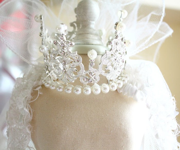 Close-up of white tulle pet veil with ornate pearl and rhinestone crown