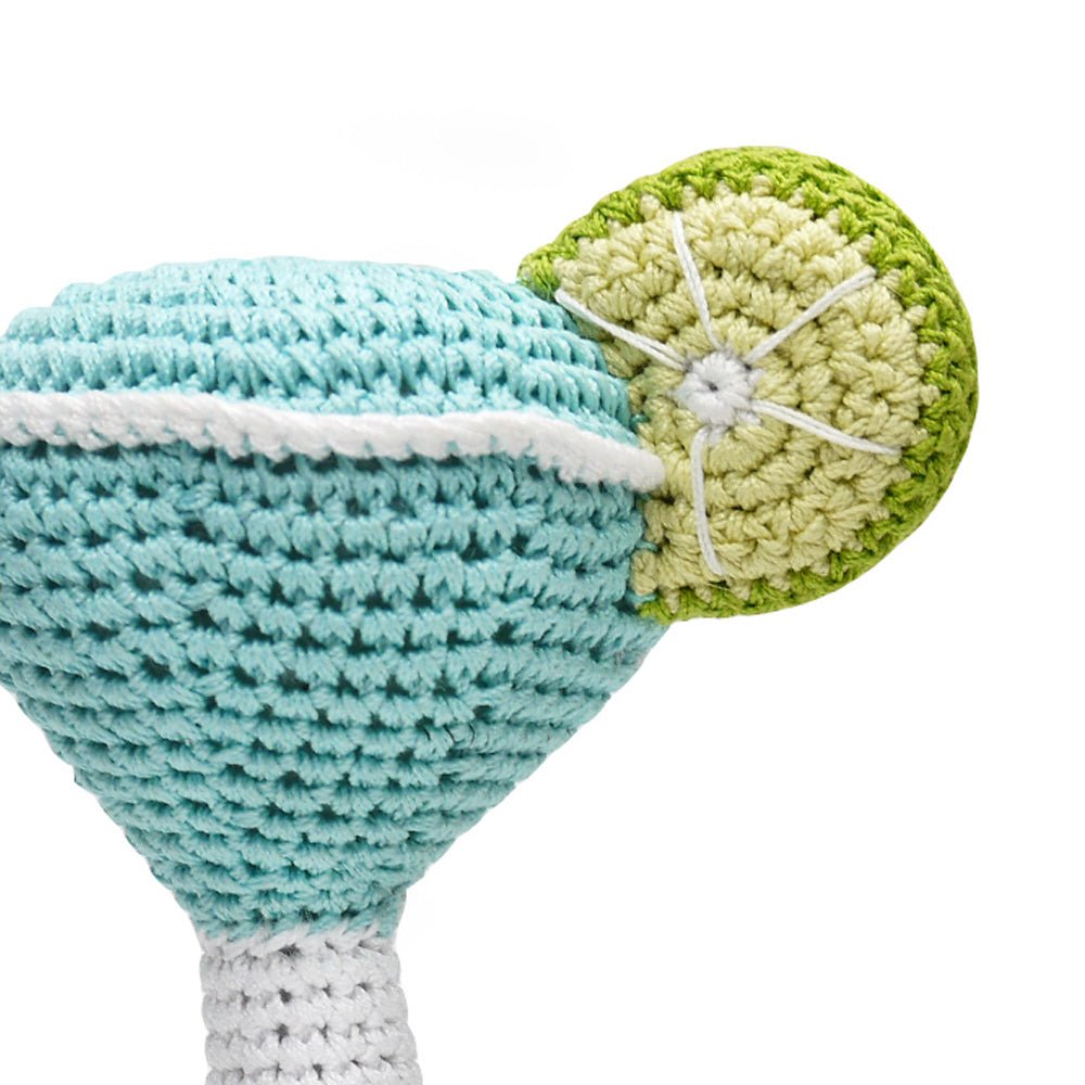 Crochet cocktail glass toy close-up, turquoise crochet with white ribbed stem and lime base