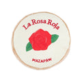 Round plush dog toy with off-white fabric, red rose patch and green leaves, Mazapaw text