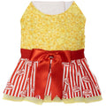 Yellow popcorn-pattern dog dress with red sash bow and red-and-white striped skirt