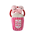 Pink plush squeaky dog toy shaped like a striped butter cup with bunny faces on top