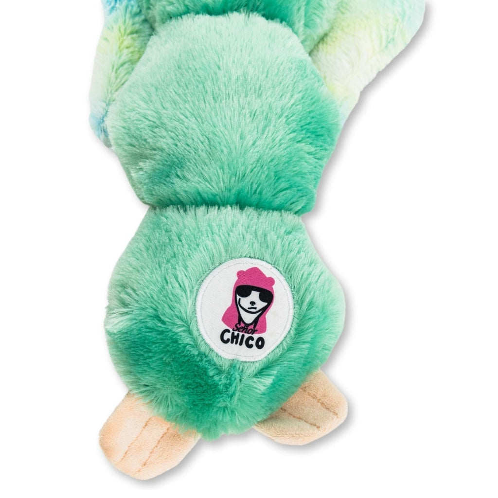 Mint green sloth plush dog toy close-up with round "Chico" badge on back