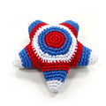 Crocheted star toy with blue, red, and white stripes and a red center emblem