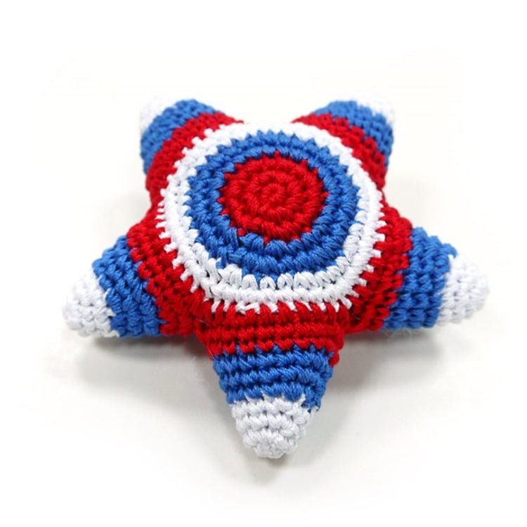 Crocheted star toy with blue, red, and white stripes and a red center emblem