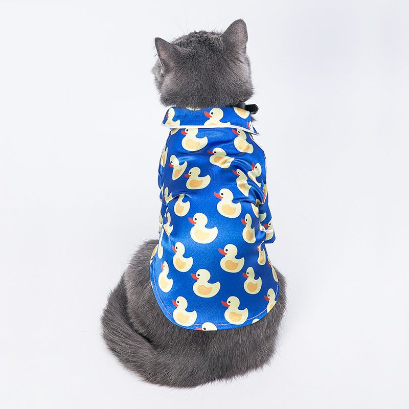 Blue duck-print pet jacket on gray cat, back view with collar opening