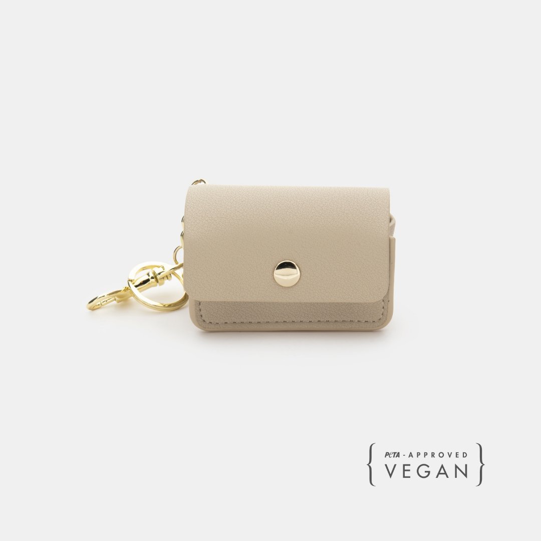 Beige vegan leather dog waste pouch with snap flap and gold chain clip