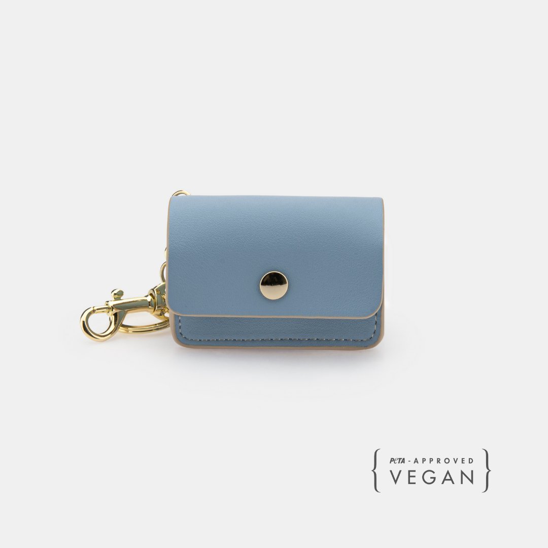 Light blue dog waste pouch with front snap button and gold key-ring clip