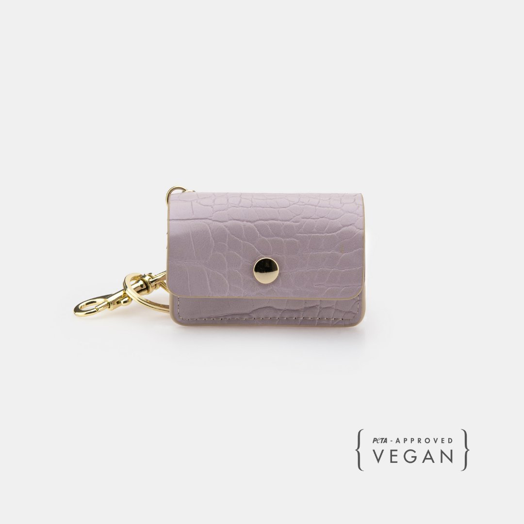 Lilac vegan leather dog waste pouch with textured finish, snap flap, and gold clip