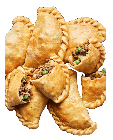 Assorted golden-brown dog empanadas with crimped edges and browned tops