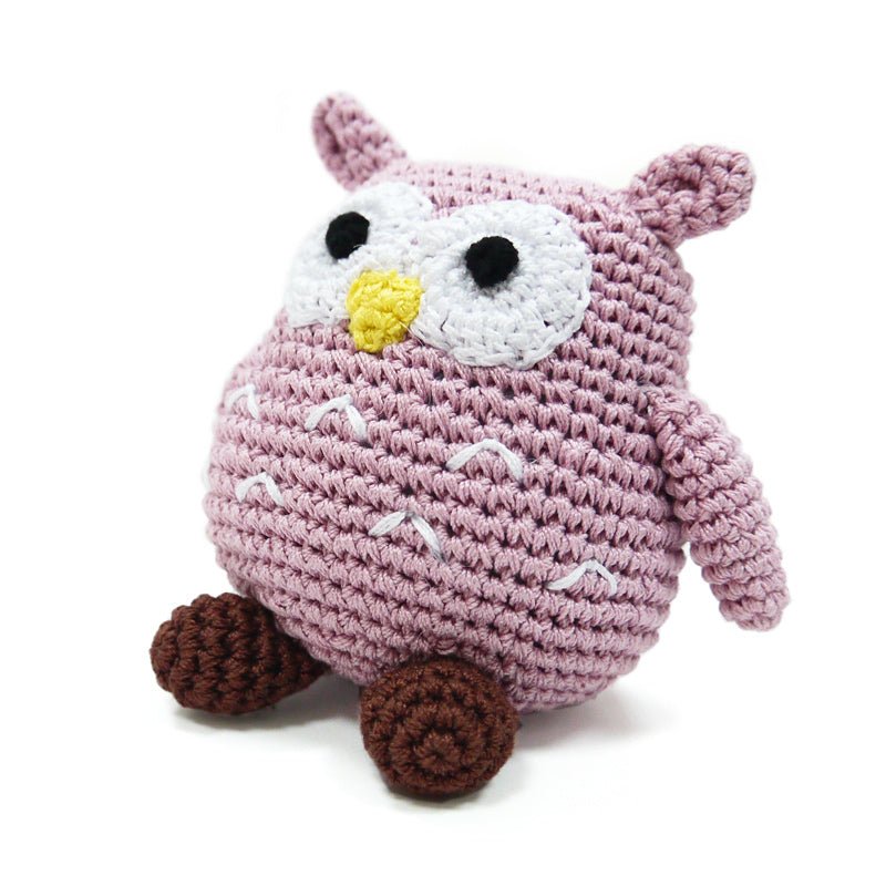 Crochet owl toy in mauve with white face, black eyes, yellow beak, and brown legs